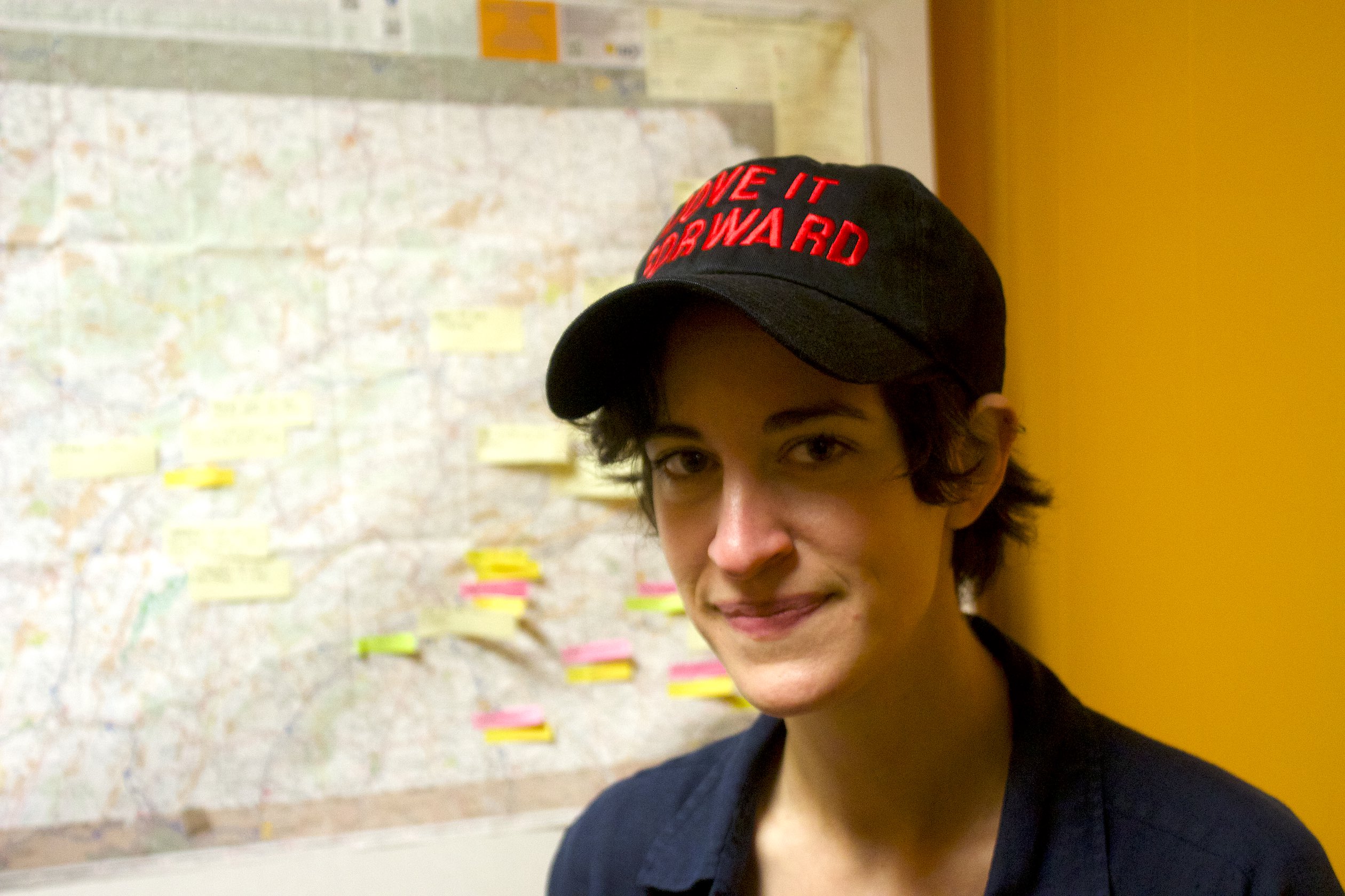 Kyla Van Buren poses for hat with the text 'Move It Forward' on it.
