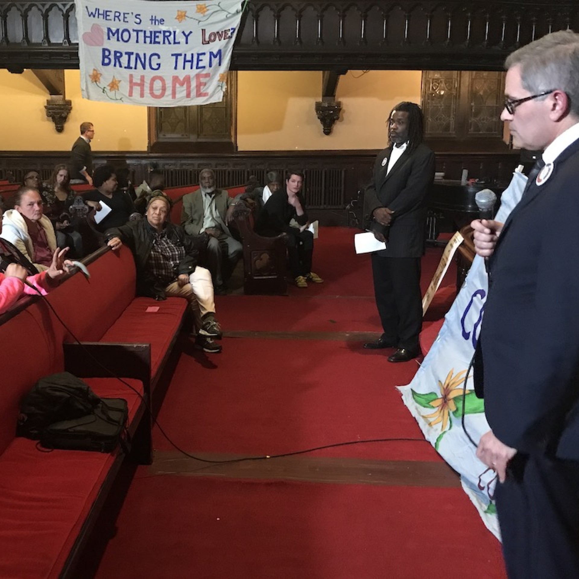 An audience member asks a question at a community forum with District Attorney Krasner