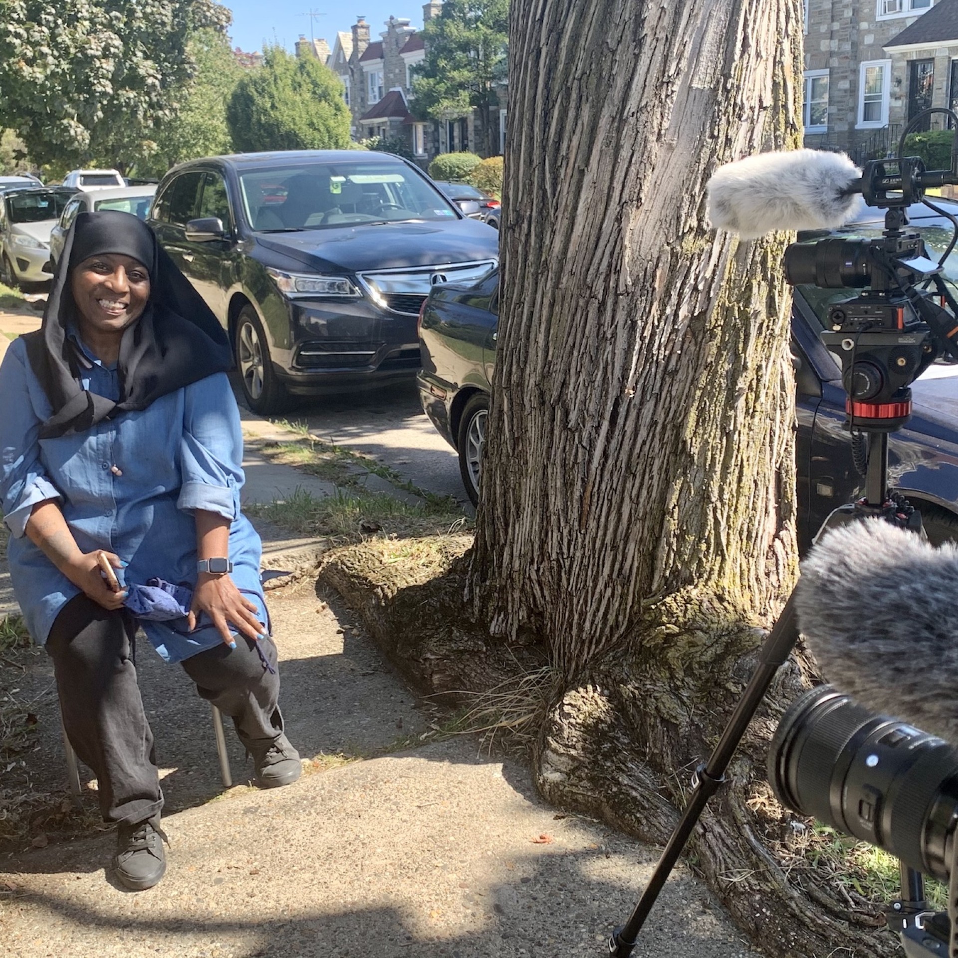 Kariymah smiles as a video crew sets up to film her. 